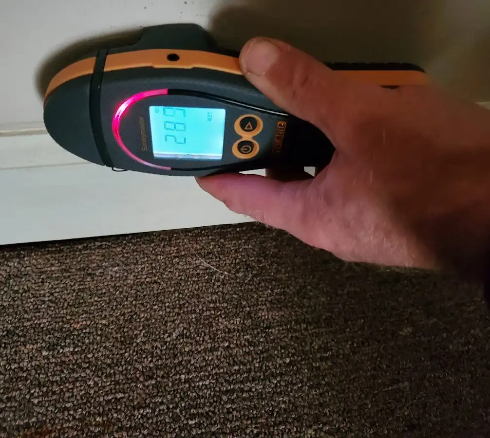 Moisture detection at baseboard during Storm Damage Restoration in Lavon